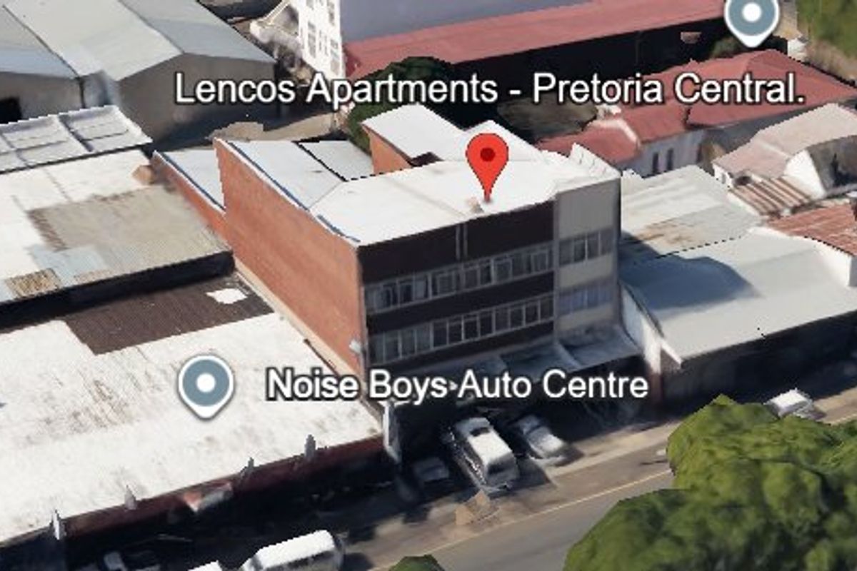Aerial view of a multi-story commercial building located in a dense urban area.