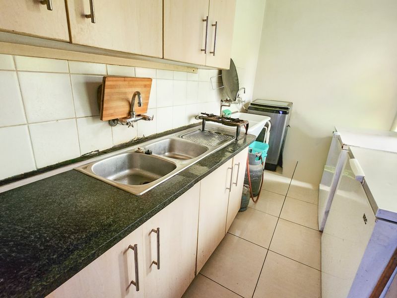 A neat three-bedroom, two-bathroom home with a double garage and a large yard for easy, comfortable living. - Photo 7