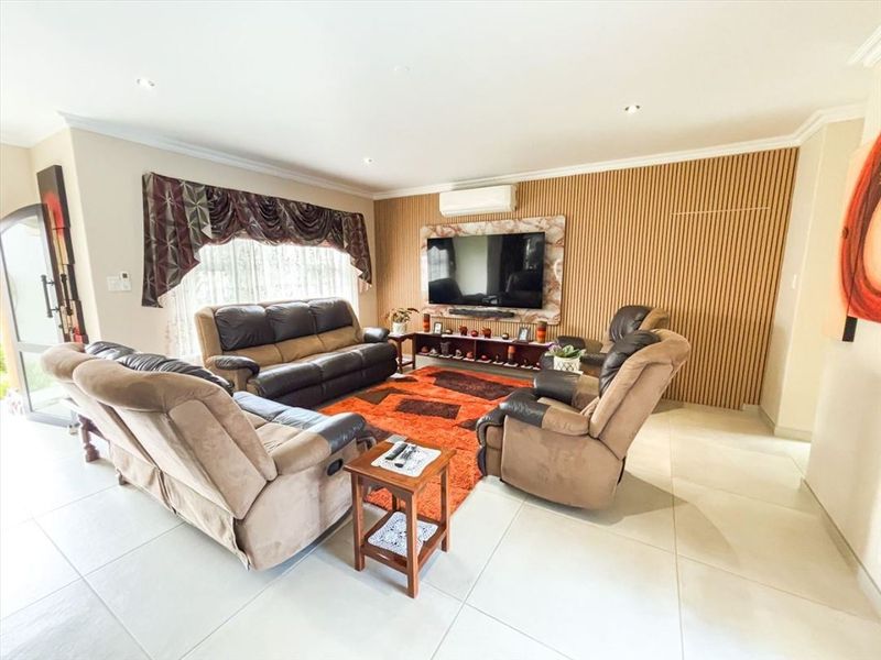 Spacious living room featuring a modern timber slat feature wall, tiled flooring, and a split system air conditioner.