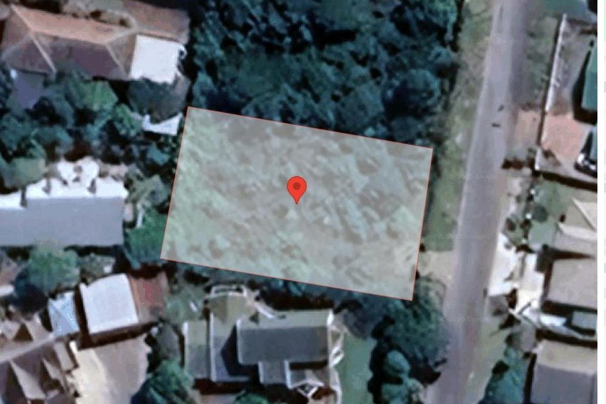 An aerial view showing the boundaries of a vacant residential plot of land.