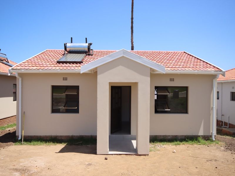 Front elevation of a modern single-story house featuring a tiled roof, solar water heating system, and a covered entrance porch.