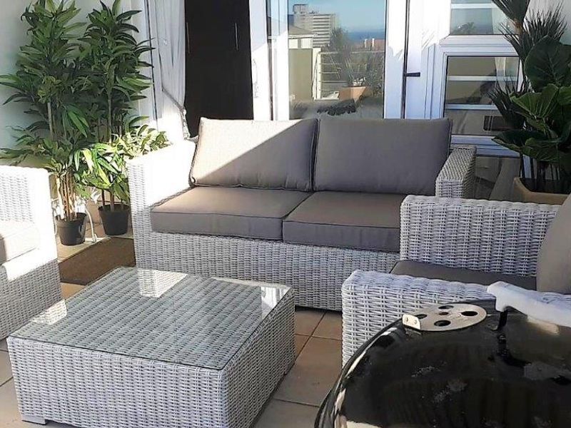 A covered balcony area featuring tiled flooring and direct access to the interior through sliding glass doors.