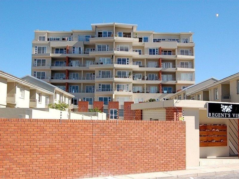 Exterior view of the Regent's View apartment complex, featuring a multi-story residential building with balconies and a secure brick perimeter wall.
