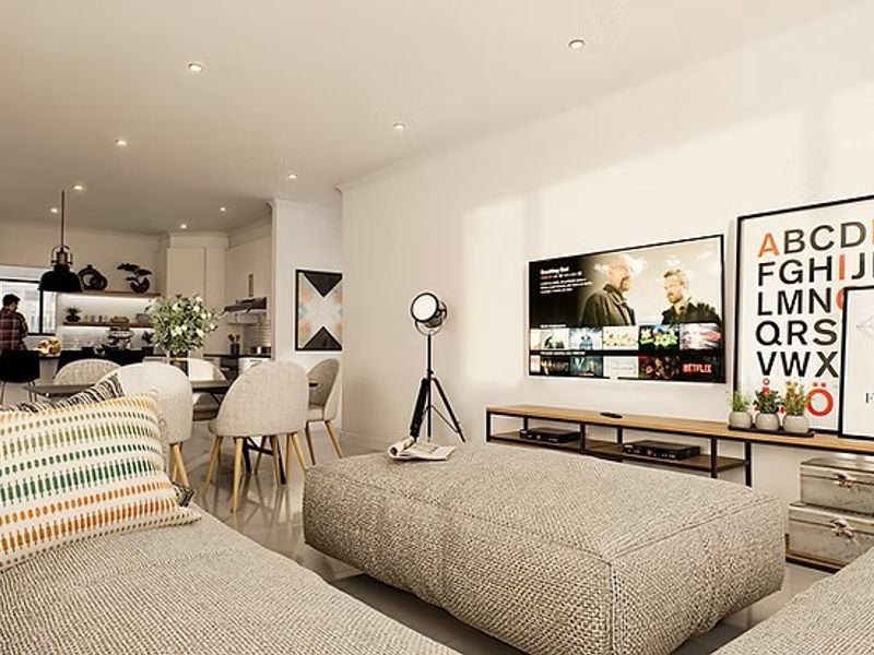 Modern open-plan living area featuring a spacious kitchen with island, recessed lighting, and tiled flooring, seamlessly flowing into the lounge space.