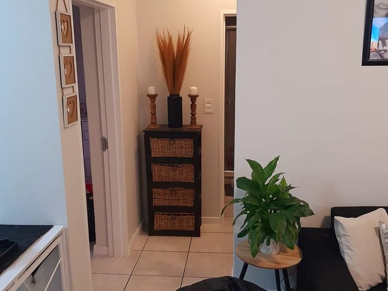 A tiled hallway area connecting to adjacent rooms, featuring neutral wall finishes and standard ceiling lighting.
