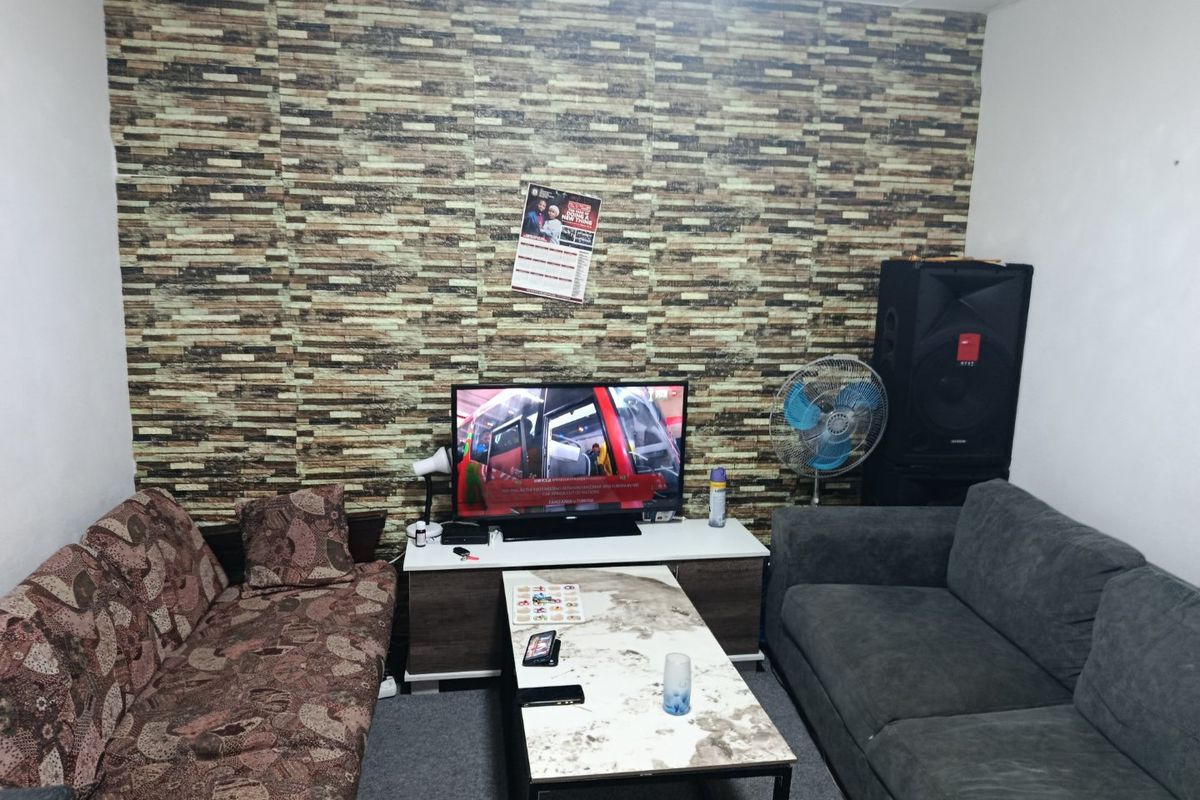 A living room featuring a prominent textured stone-effect feature wall, providing a focal point for the space.