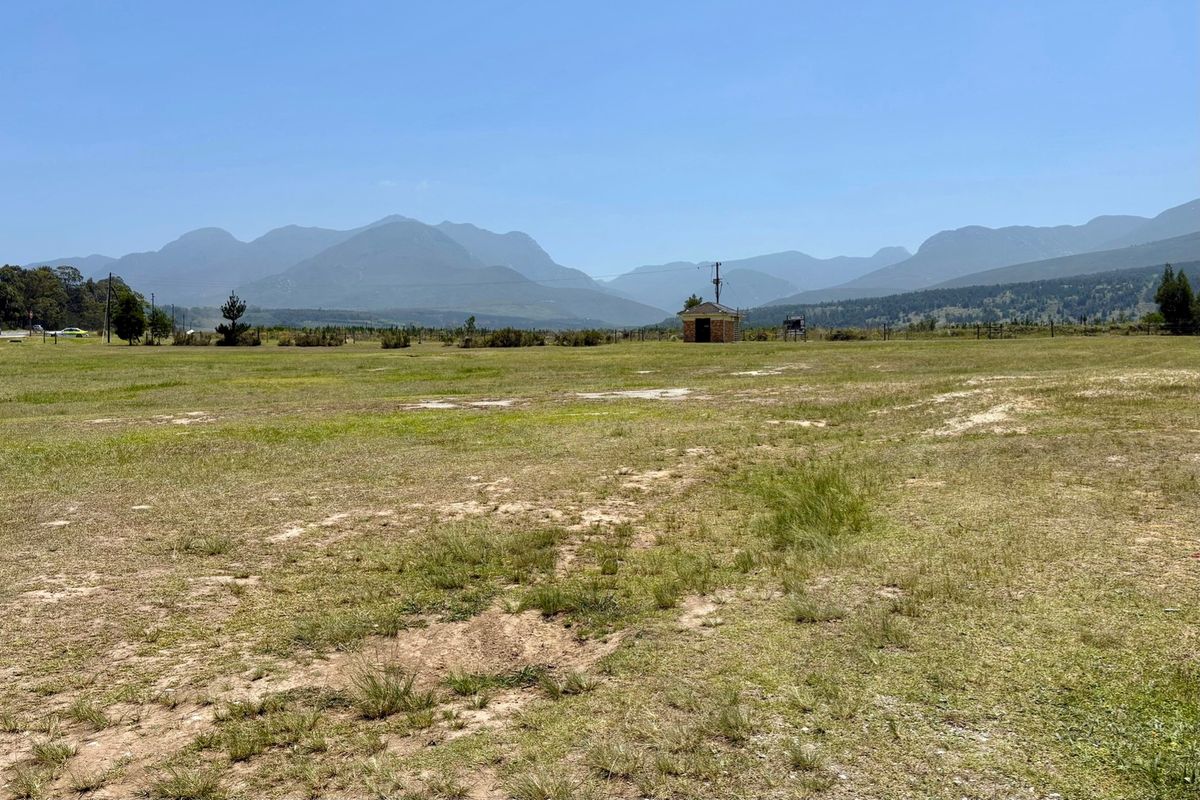 Expansive vacant residential land featuring scenic mountain views and open grassy terrain.