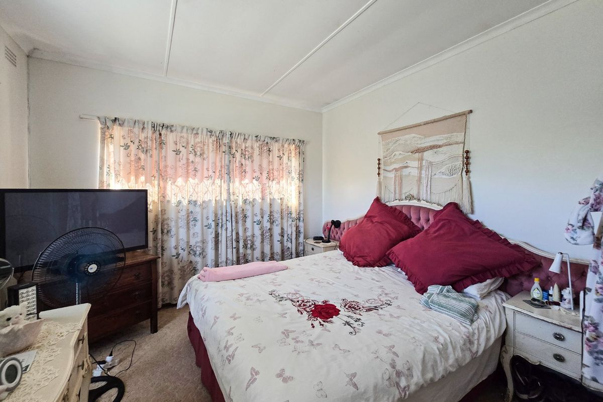 A bedroom featuring carpeted flooring and standard ceiling finishes, offering a functional space ready for cosmetic updates.