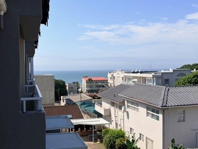 An elevated view overlooking the surrounding neighborhood with a clear perspective of the distant ocean horizon.