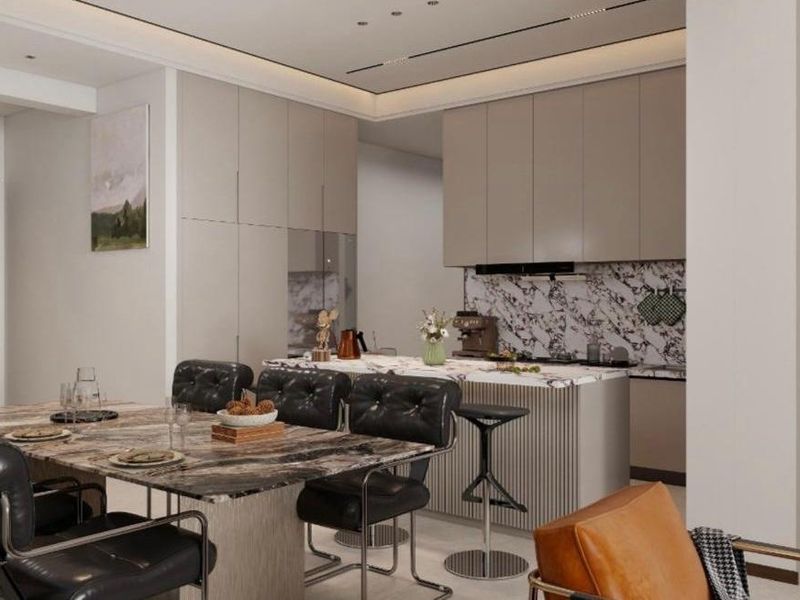 Modern open-plan kitchen and dining area featuring marble finishes, sleek built-in cabinetry, and integrated lighting for a sophisticated, contemporary aesthetic.