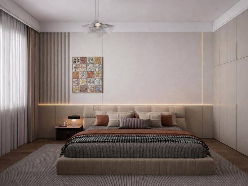A modern, elegantly designed bedroom featuring custom built-in wardrobes, sophisticated fluted wall paneling, and integrated ambient LED lighting.