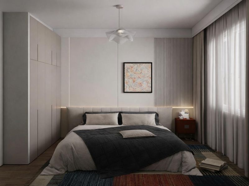 A modern, well-appointed bedroom featuring custom built-in wardrobes, textured wall paneling with integrated accent lighting, and a contemporary pendant light fixture.