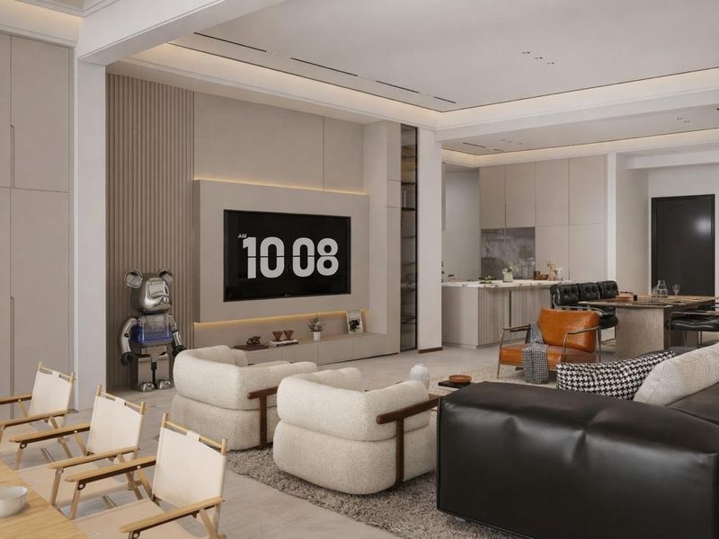 Modern open-plan living area featuring a sleek media wall, recessed lighting, and a contemporary kitchen with a stone island and integrated cabinetry.