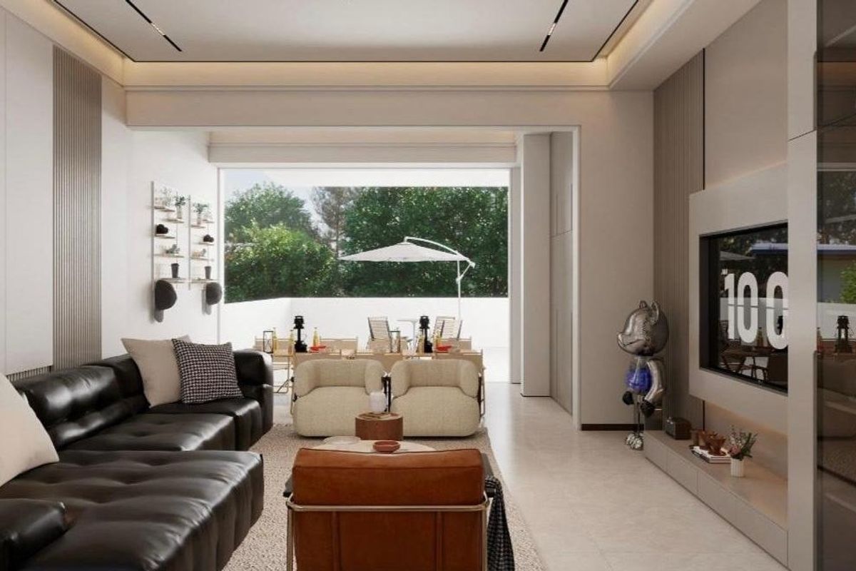 Modern open-plan living area featuring sleek built-in media cabinetry, recessed ceiling lighting, and seamless transition to an outdoor patio space.