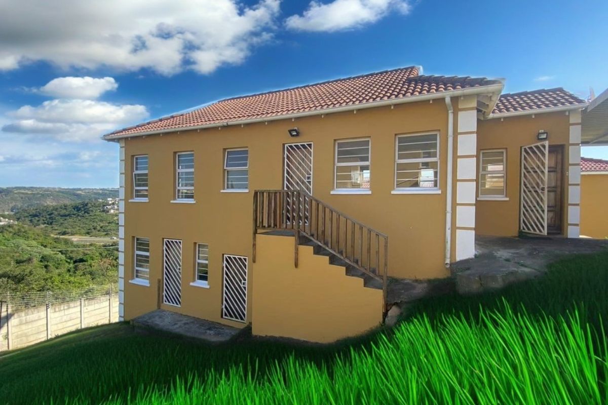 Rear view of the townhouse featuring a multi-level exterior with terracotta roof tiles, security gates, and an external staircase leading to the upper level.