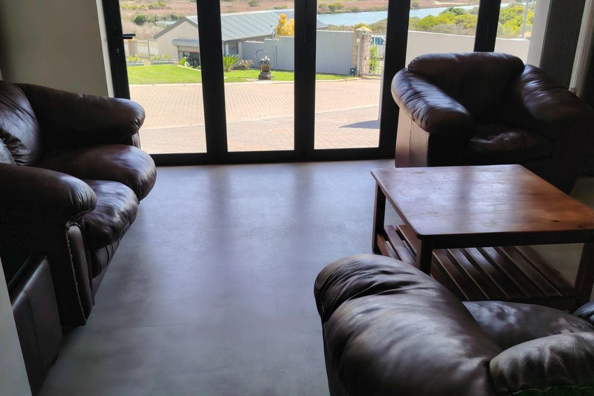 Spacious living area featuring large glass sliding doors that provide abundant natural light and views of the exterior landscape.
