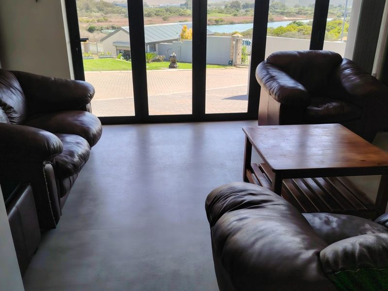 Spacious living area featuring large glass sliding doors that provide abundant natural light and views of the exterior landscape.