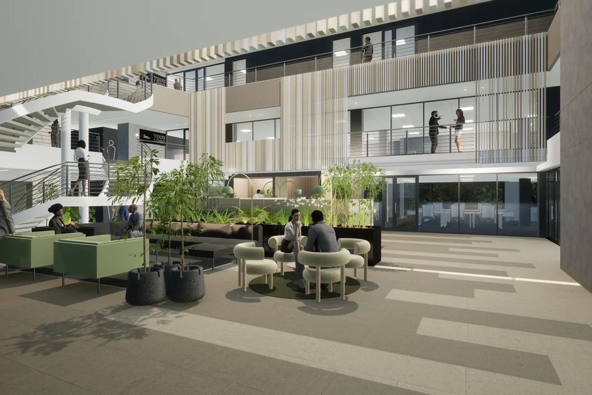 A modern commercial courtyard featuring a multi-level atrium, architectural staircase, and open-air design with integrated timber screening and glass balustrades.