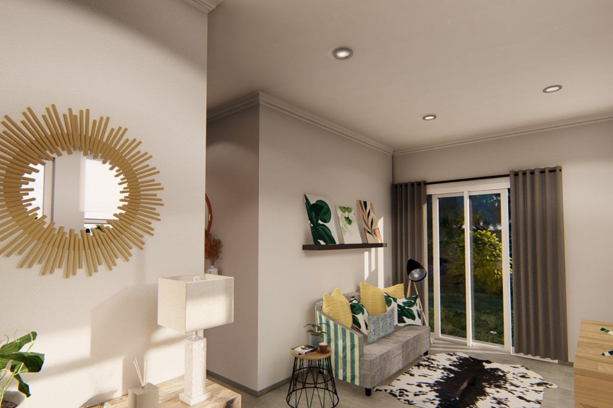A well-lit living room featuring recessed downlights, coving, and a sliding glass door providing access to the outdoor area.