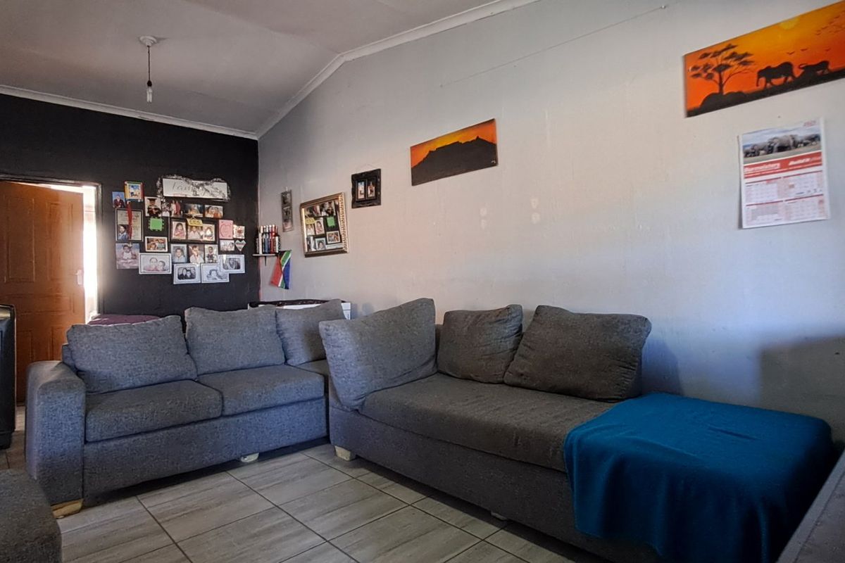 A living room featuring tiled flooring and neutral wall finishes, providing a functional space for relaxation.