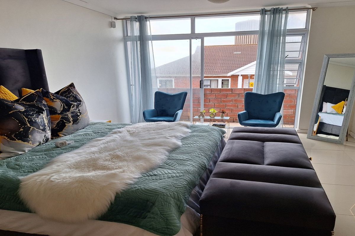 Spacious bedroom featuring large sliding glass doors that provide natural light and access to a private balcony area.