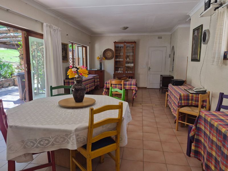 Spacious open-plan living and dining area featuring tiled flooring and large sliding glass doors providing direct access to the outdoor patio.