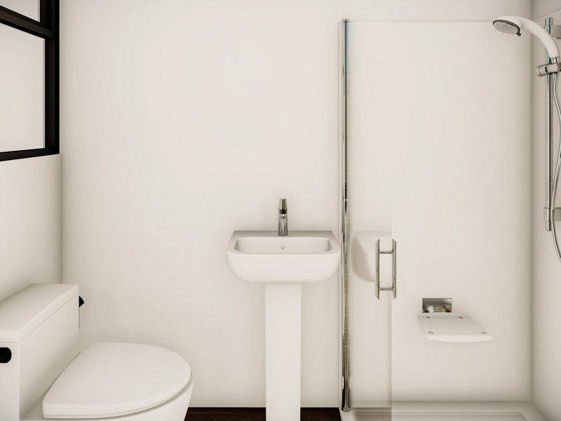 A clean, modern bathroom featuring a pedestal sink, a walk-in shower with a seat, and a standard toilet.