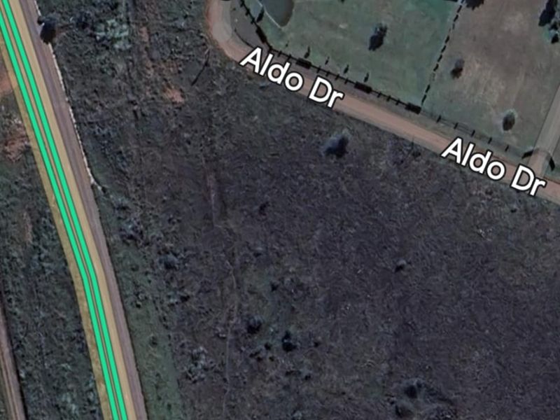 Aerial view of a vacant residential plot located at the corner of Ursala Street and Aldo Drive.