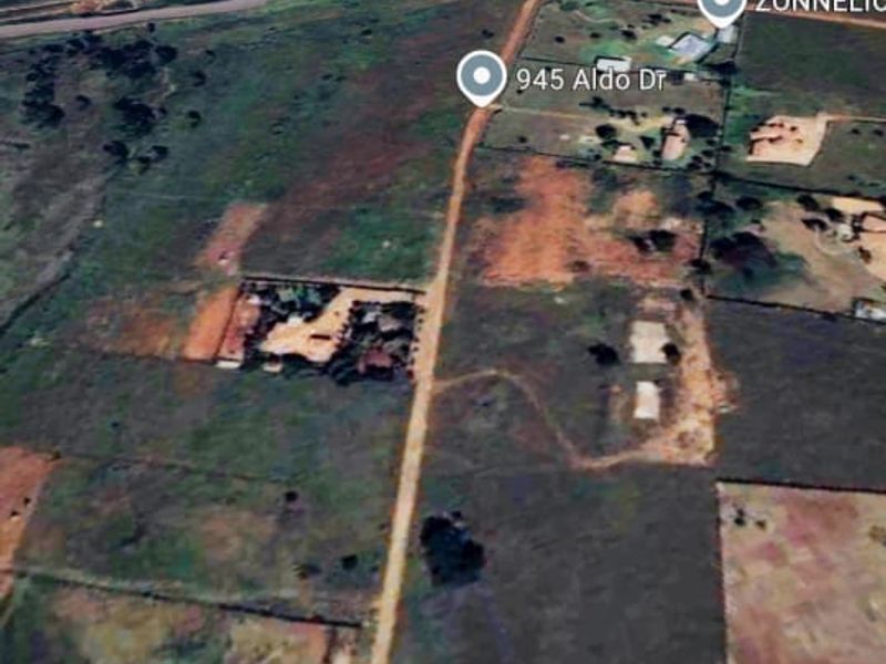 An aerial satellite view showing the residential land plot and surrounding rural landscape.