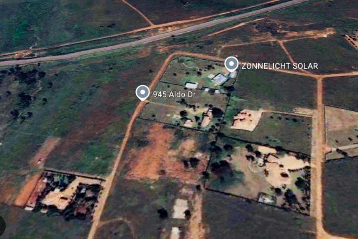 An aerial view of the residential vacant land plot showing surrounding terrain and access roads.