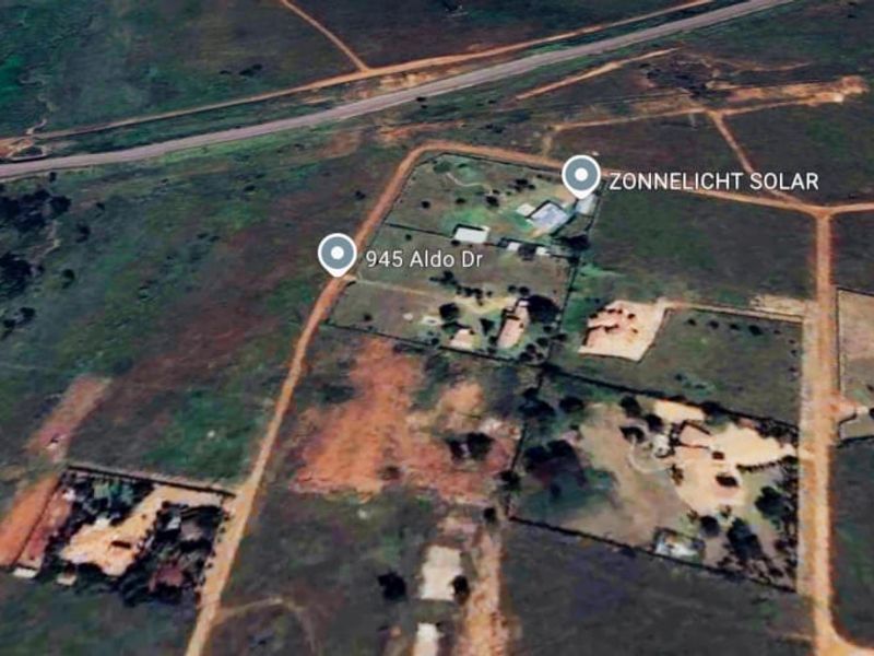 An aerial view of the residential vacant land plot showing surrounding terrain and access roads.