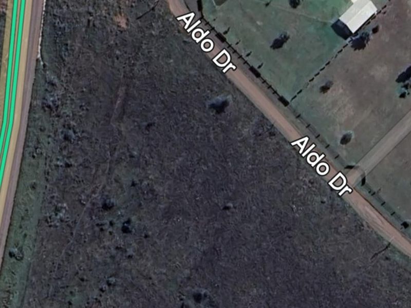 Aerial view of a vacant residential plot located at the corner of Ursala Street and Aldo Drive.