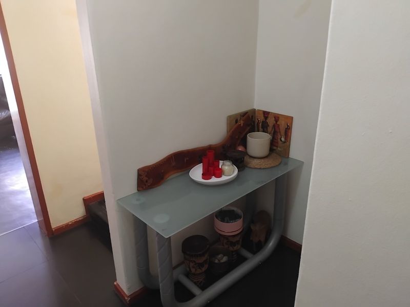 A small hallway alcove area featuring neutral wall finishes and tiled flooring.