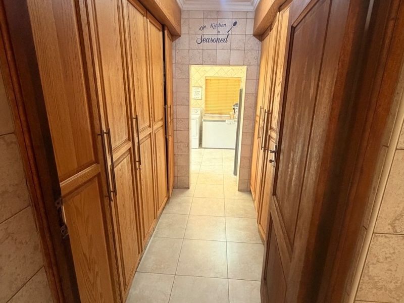 Modern Double-Storey Family Home on a Plot – Luxury Living at Its Best!  Step into elegance with this stunning modern double-storey home situated on a spacious plot, offering comfort, style, and exceptional entertainment features — perfect for a large family who loves both space and sophistication. Property Features: 	•	3 Spacious Bedrooms 	•	Dedicated Study / Home Office 	•	Stylish Makeup Room / Dressing Room 	•	3 Modern Bathrooms  	•	Beautiful, Modern Kitchen with Quality Finishes Separate Laundry Room 	•	2 Comfortable Lounges 	•	Elegant Dining Room  ?? Parking & Extras: 	•	3 Garages with Ample Parking Space 	•	Situated on a Plot – Peaceful and Private Living  ?? Entertainment & Outdoor Living: 	•	Sparkling Swimming Pool 	•	Lapa with Entertainment Area – Perfect for Hosting Family & Friends 	•	Spacious Yard with Plenty of Room for Kids to Enjoy  This home is very neat, modern, and move-in ready, offering the perfect balance between luxury and family living. - Photo 5