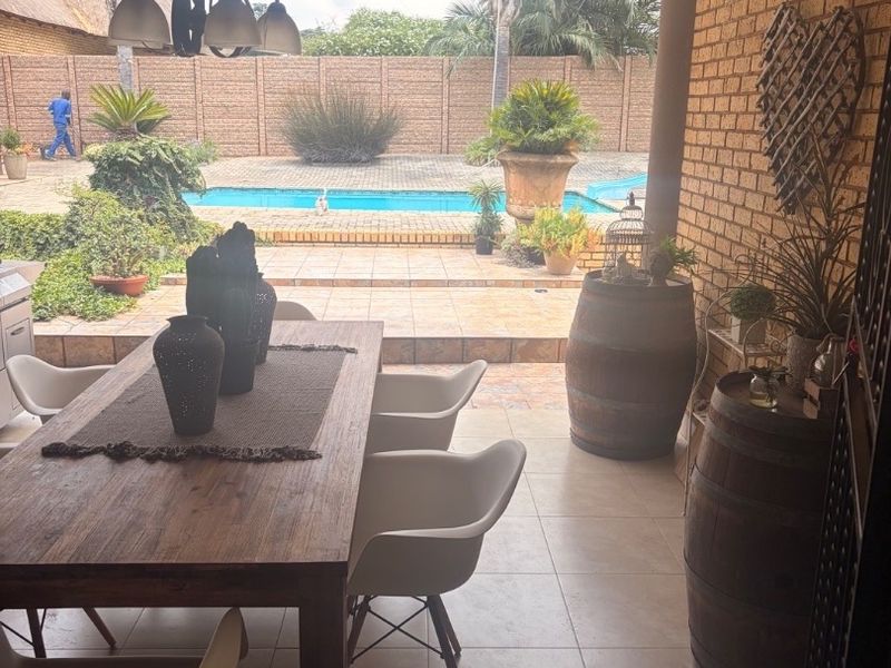 Modern Double-Storey Family Home on a Plot – Luxury Living at Its Best!  Step into elegance with this stunning modern double-storey home situated on a spacious plot, offering comfort, style, and exceptional entertainment features — perfect for a large family who loves both space and sophistication. Property Features: 	•	3 Spacious Bedrooms 	•	Dedicated Study / Home Office 	•	Stylish Makeup Room / Dressing Room 	•	3 Modern Bathrooms  	•	Beautiful, Modern Kitchen with Quality Finishes Separate Laundry Room 	•	2 Comfortable Lounges 	•	Elegant Dining Room  ?? Parking & Extras: 	•	3 Garages with Ample Parking Space 	•	Situated on a Plot – Peaceful and Private Living  ?? Entertainment & Outdoor Living: 	•	Sparkling Swimming Pool 	•	Lapa with Entertainment Area – Perfect for Hosting Family & Friends 	•	Spacious Yard with Plenty of Room for Kids to Enjoy  This home is very neat, modern, and move-in ready, offering the perfect balance between luxury and family living. - Photo 9