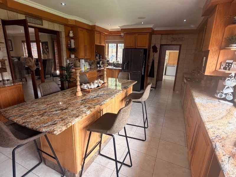 Modern Double-Storey Family Home on a Plot – Luxury Living at Its Best!  Step into elegance with this stunning modern double-storey home situated on a spacious plot, offering comfort, style, and exceptional entertainment features — perfect for a large family who loves both space and sophistication. Property Features: 	•	3 Spacious Bedrooms 	•	Dedicated Study / Home Office 	•	Stylish Makeup Room / Dressing Room 	•	3 Modern Bathrooms  	•	Beautiful, Modern Kitchen with Quality Finishes Separate Laundry Room 	•	2 Comfortable Lounges 	•	Elegant Dining Room  ?? Parking & Extras: 	•	3 Garages with Ample Parking Space 	•	Situated on a Plot – Peaceful and Private Living  ?? Entertainment & Outdoor Living: 	•	Sparkling Swimming Pool 	•	Lapa with Entertainment Area – Perfect for Hosting Family & Friends 	•	Spacious Yard with Plenty of Room for Kids to Enjoy  This home is very neat, modern, and move-in ready, offering the perfect balance between luxury and family living. - Photo 2