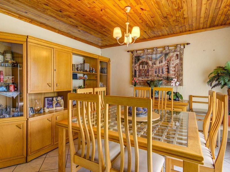 Dining room featuring a timber-clad ceiling, ceramic floor tiles, and built-in wooden cabinetry.