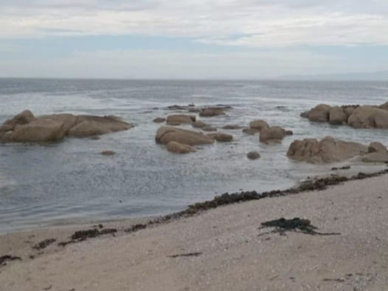 A scenic view of the rocky coastline and ocean, highlighting the natural beauty of the property's surroundings.