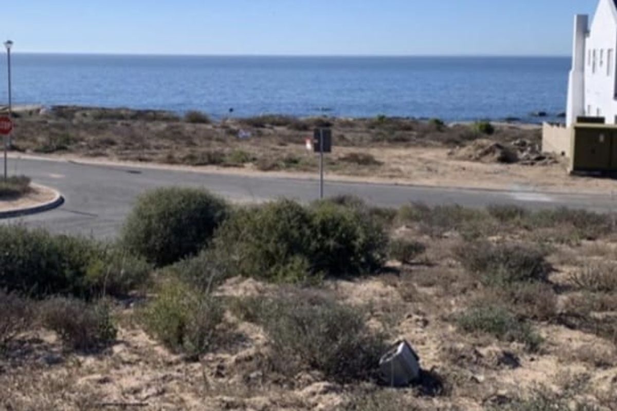 A scenic view of the ocean and coastal landscape from the vacant residential land plot.