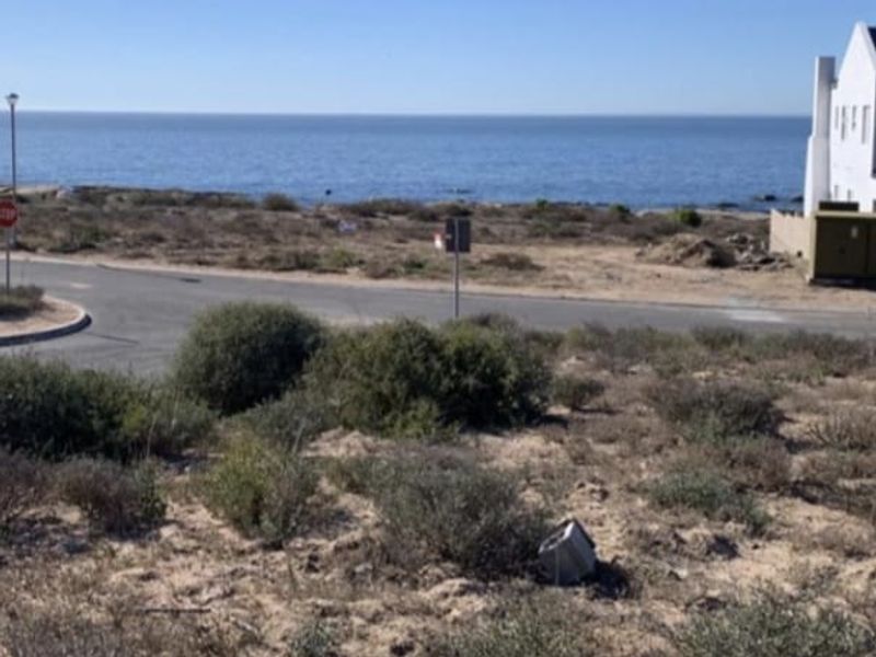A scenic view of the ocean and coastal landscape from the vacant residential land plot.