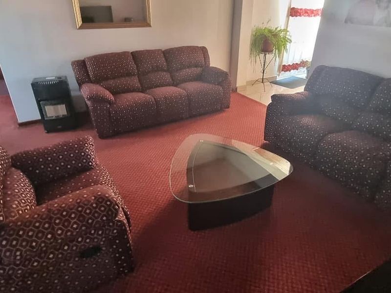 A spacious living room featuring wall-to-wall carpeting and a neutral layout, providing a comfortable and functional area for relaxation.
