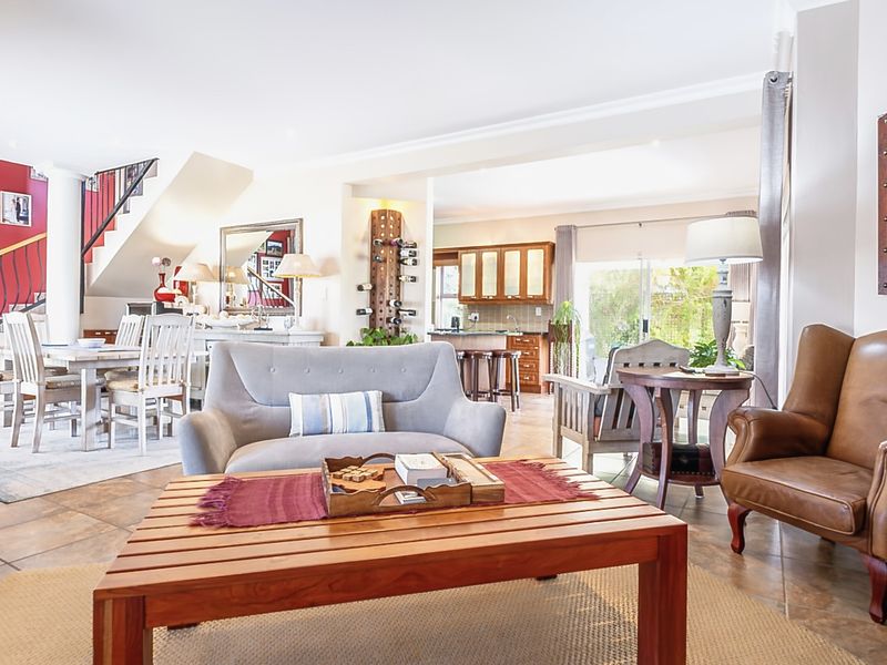 Spacious open-plan living area featuring tiled floors, a built-in fireplace, and a seamless flow to the kitchen and dining space.