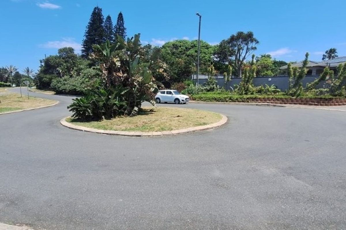 A view of the residential street and cul-de-sac approach, featuring paved roads, established landscaping, and surrounding residential properties.