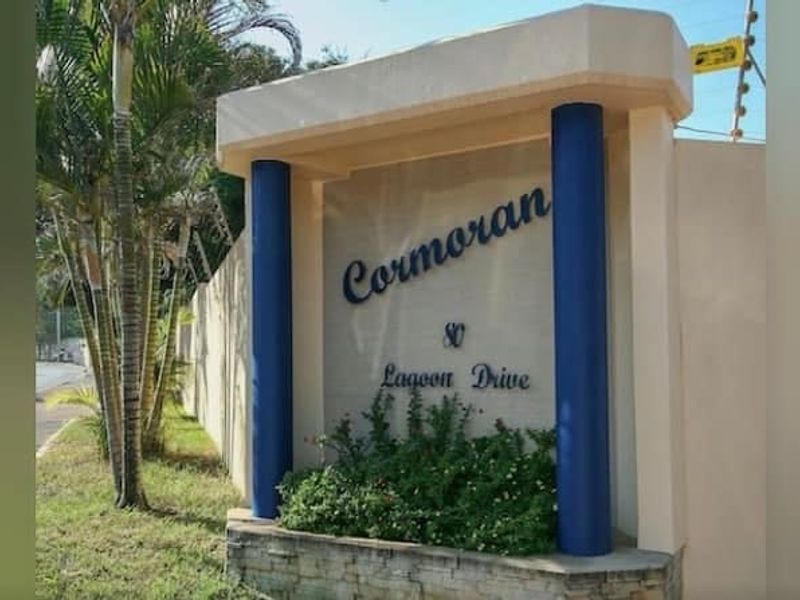 Entrance signage and boundary wall for Cormoran apartment complex located at 80 Lagoon Drive.