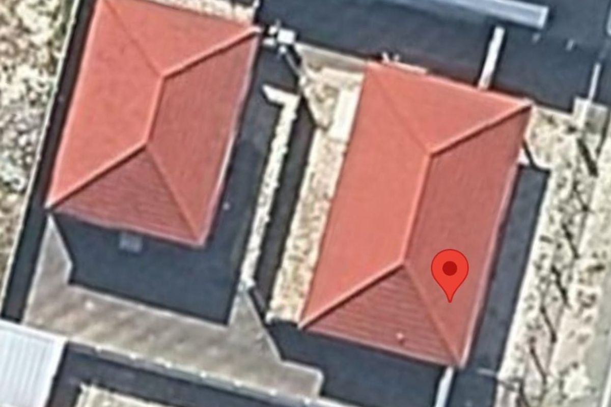 An aerial view showing the roof structure and layout of the property and adjacent building.