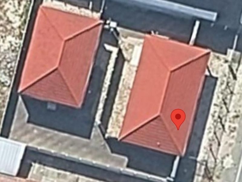 An aerial view showing the roof structure and layout of the property and adjacent building.