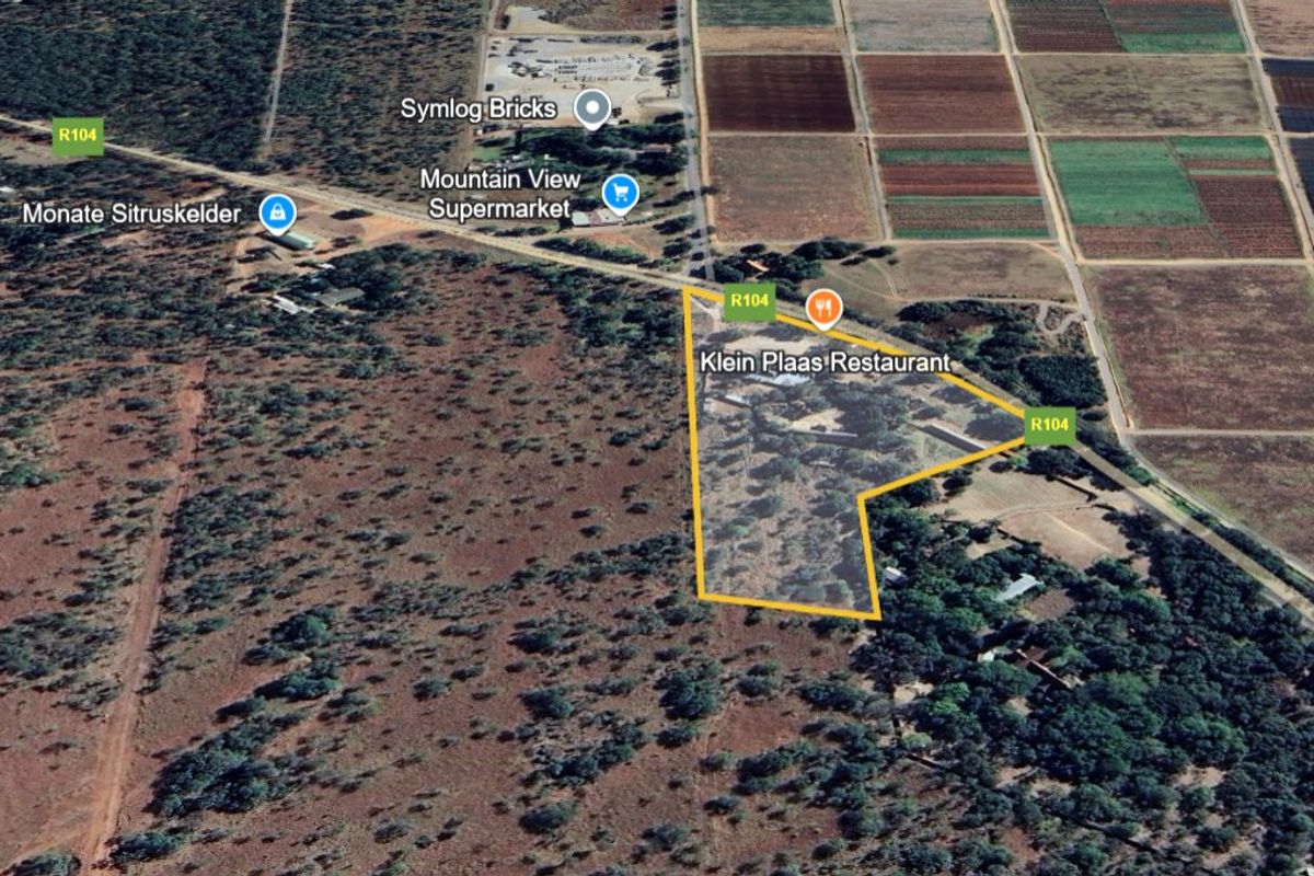 Aerial view of a commercial land parcel located along the R104 road, highlighting the property boundaries and surrounding landscape.