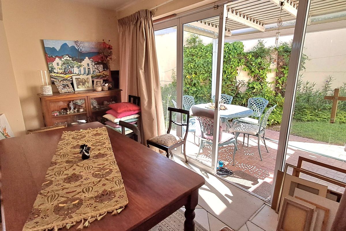 Living area featuring large sliding glass doors that provide seamless access to a covered patio and private garden space.