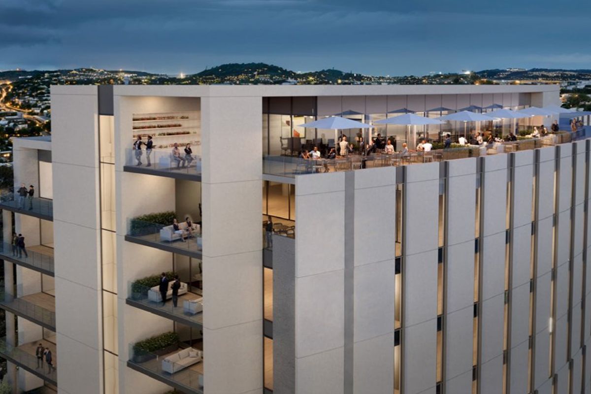 Aerial view of a modern commercial building featuring a rooftop terrace, multi-level balconies with glass balustrades, and a contemporary facade design.