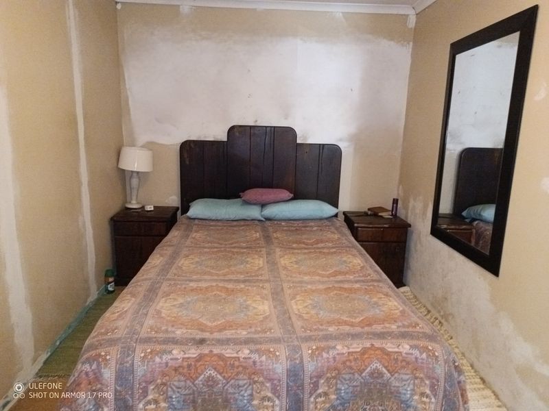 A bedroom featuring unfinished wall surfaces requiring plastering and painting to complete the room's aesthetic.